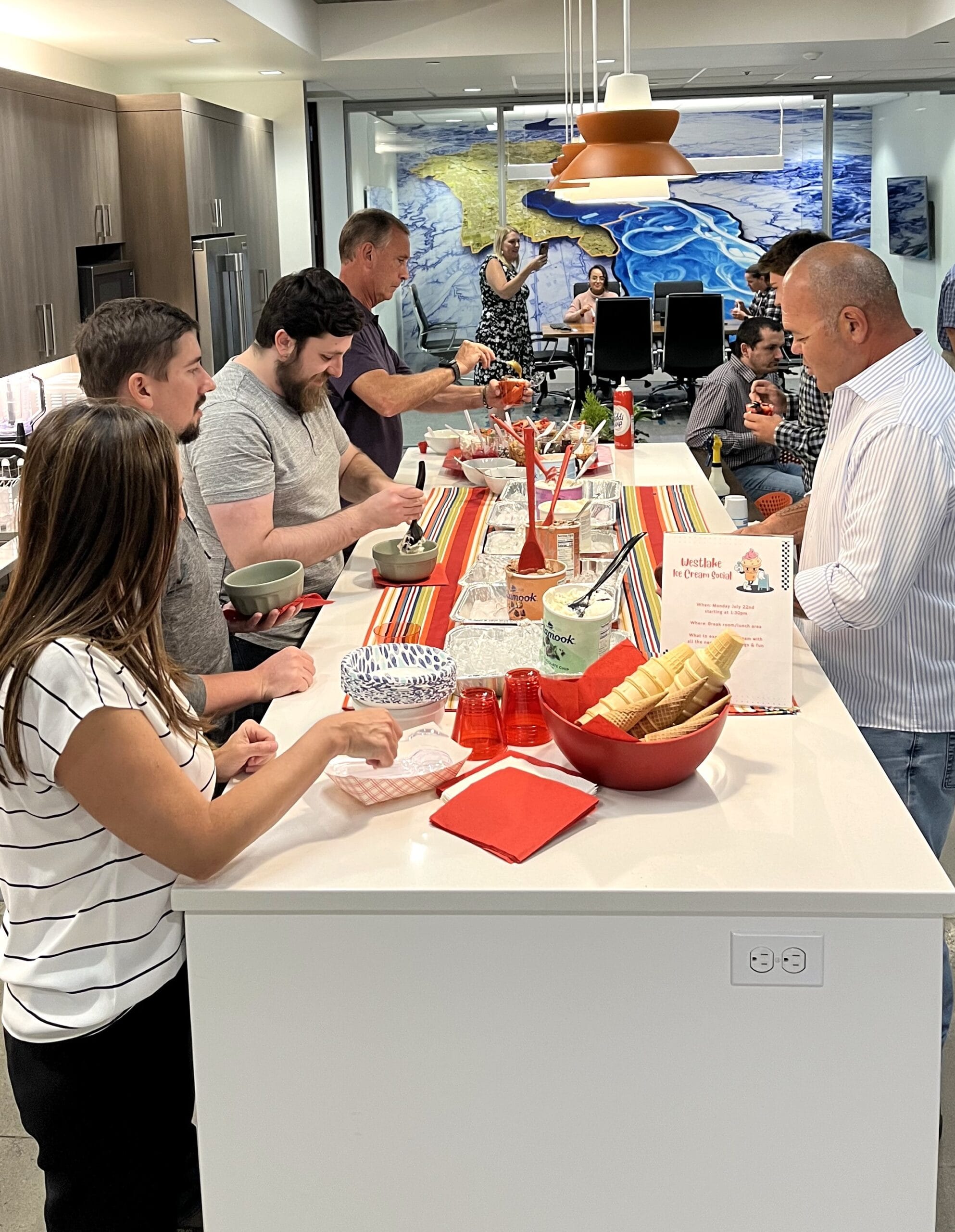 Westlake employees gathered around a table with ice cream fixings